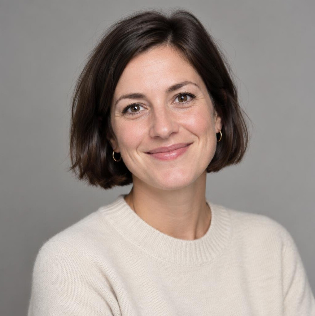 Studio portrait of a Belgian woman editorial producer smiling